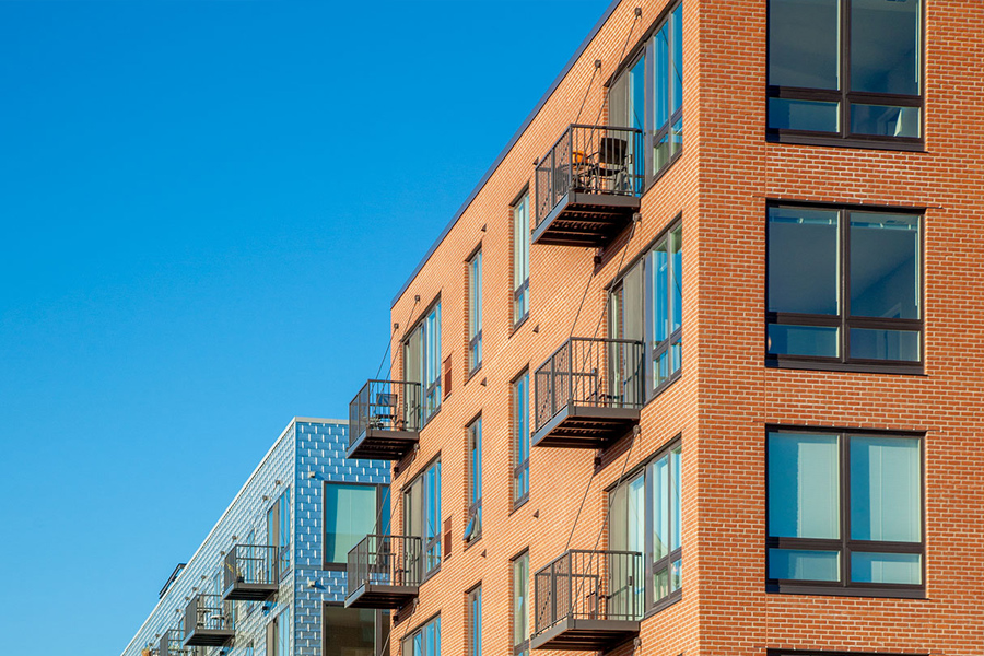 Modern brick apartment building with balconies 