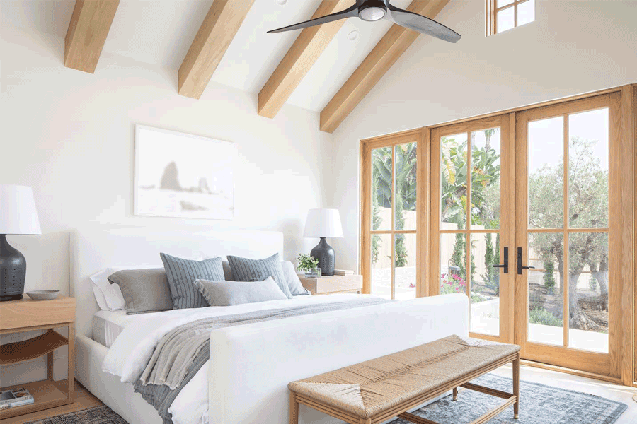 A bedroom with French doors opening to a patio.