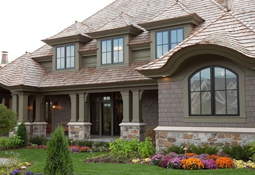 A modern farmhouse features shed dormer Andersen windows