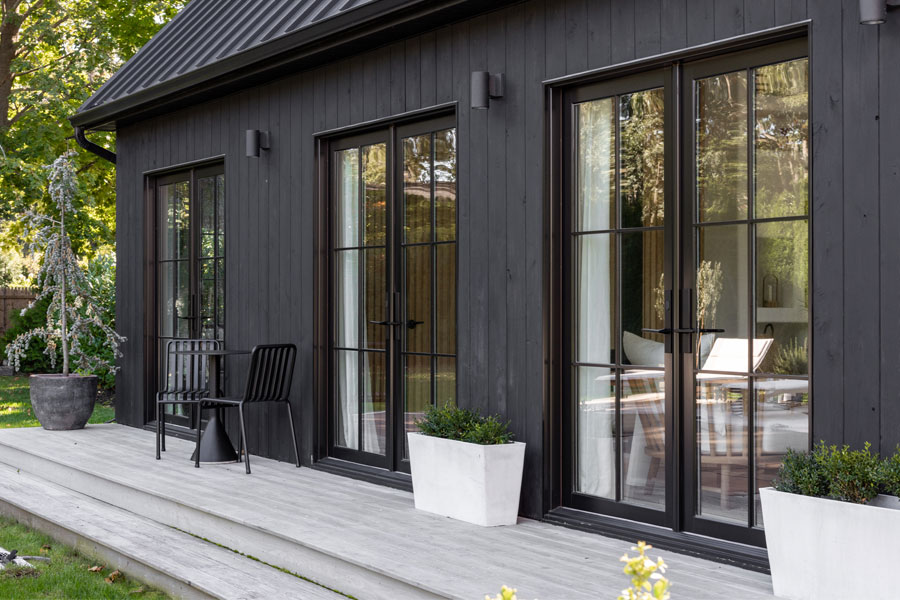 exterior view of black house with andersen black framed windows and door