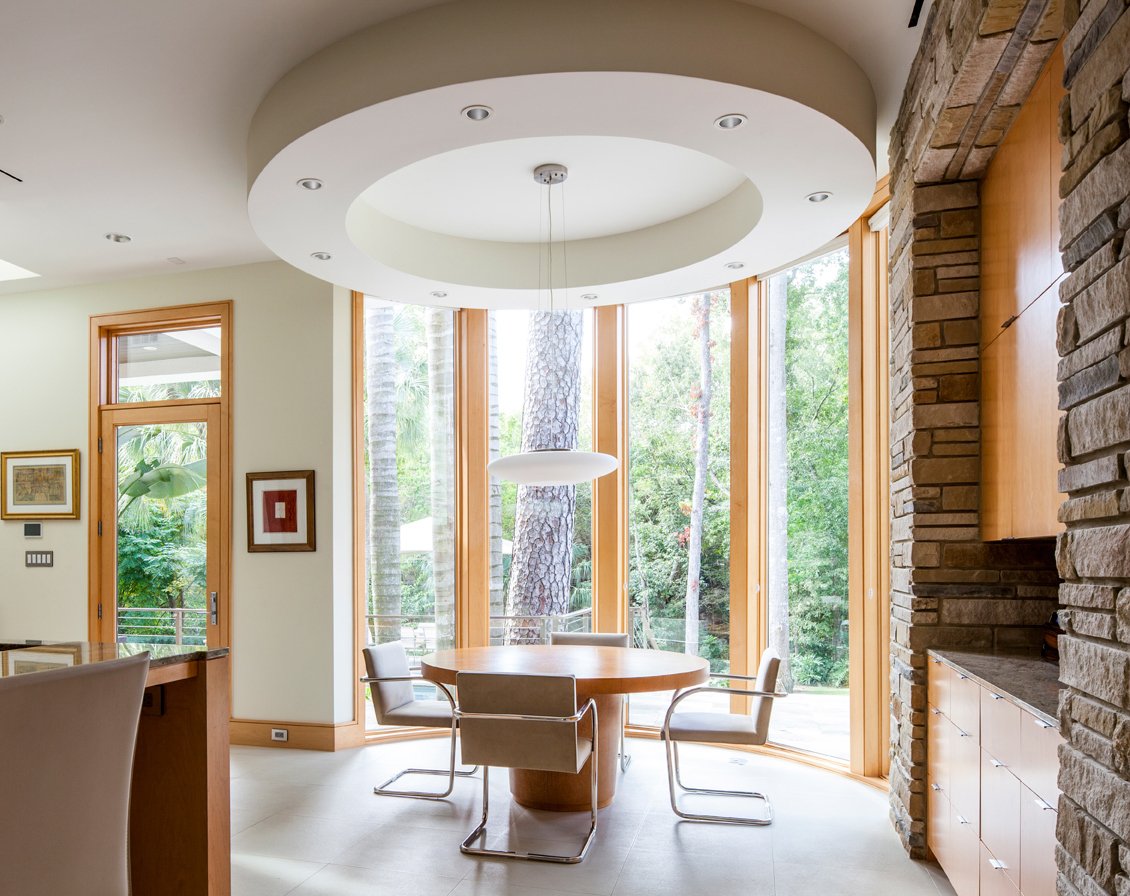 A modern home with a floor-to-ceiling window combination made of Andersen® E-Series Picture Windows.