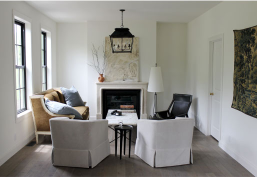 A limestone fireplace and lantern-style light fixture are the central elements in this European farmhouse living room.