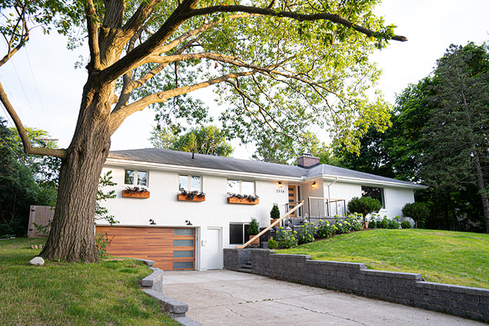 A 1950s ranch home after window replacement and remodeling on the left and before on the right.