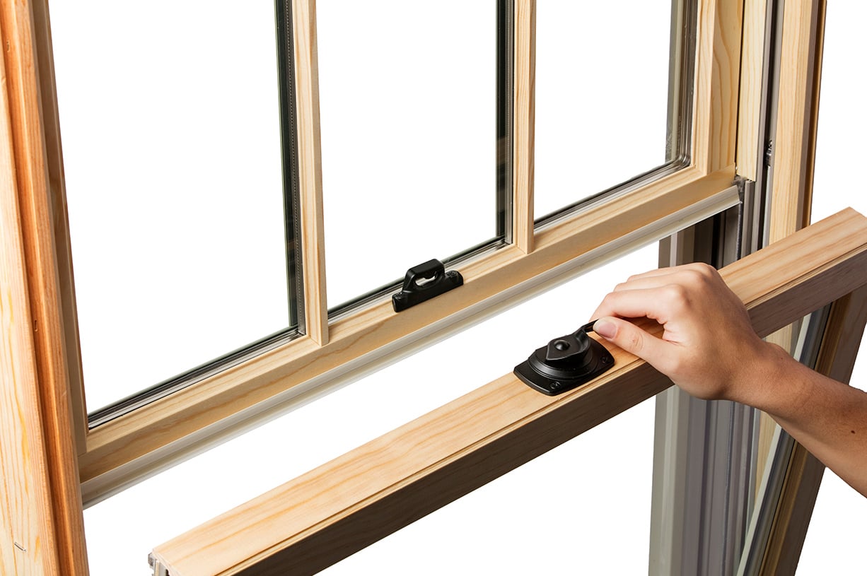 A closeup photo of an Andersen A-Series Double-Hung Window—the bottom sash of which is being tilted inward.