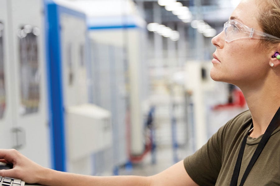 women working on computer in manufacturing area