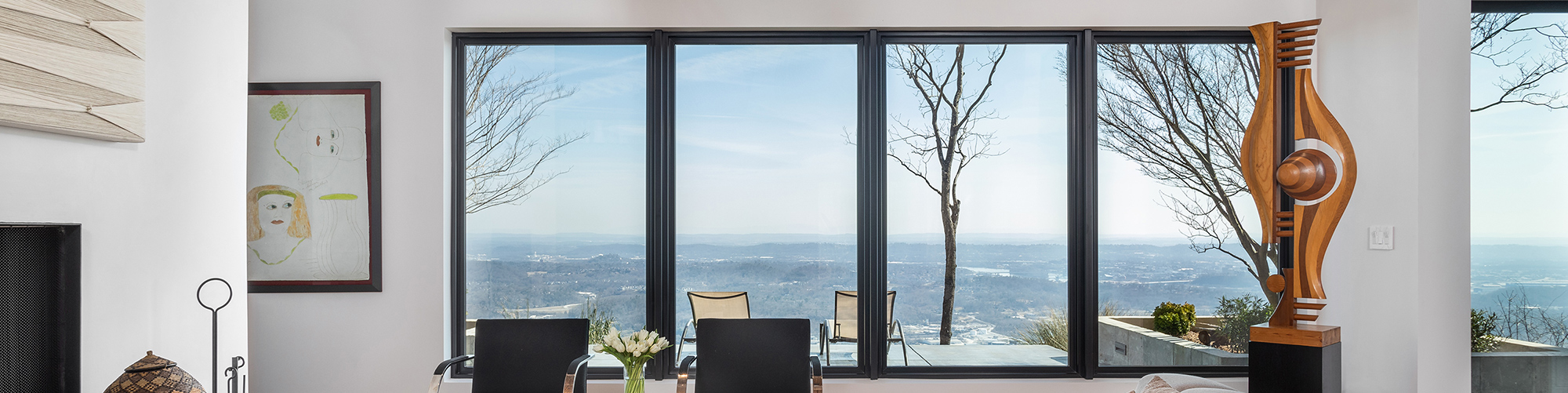 Modern, sleek living room with large sliding doors overlooking amazing views