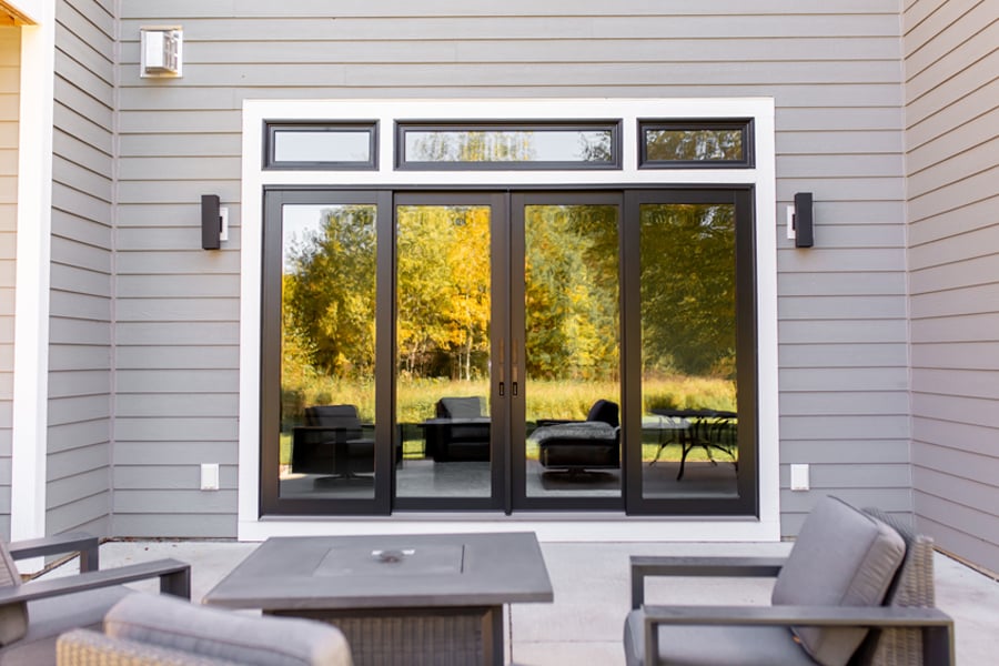 A patio with a four-panel Andersen A-Series Gliding Patio Door with transom windows above.