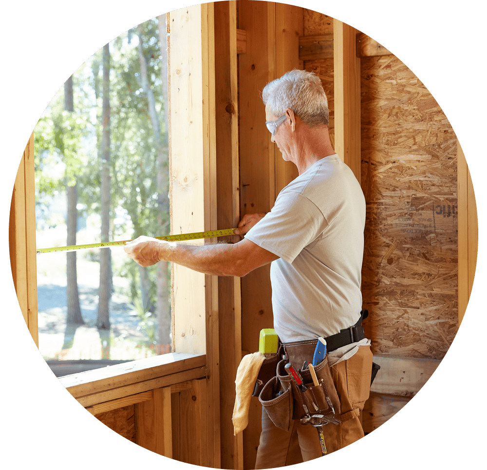 Contractor measuring a rough opening