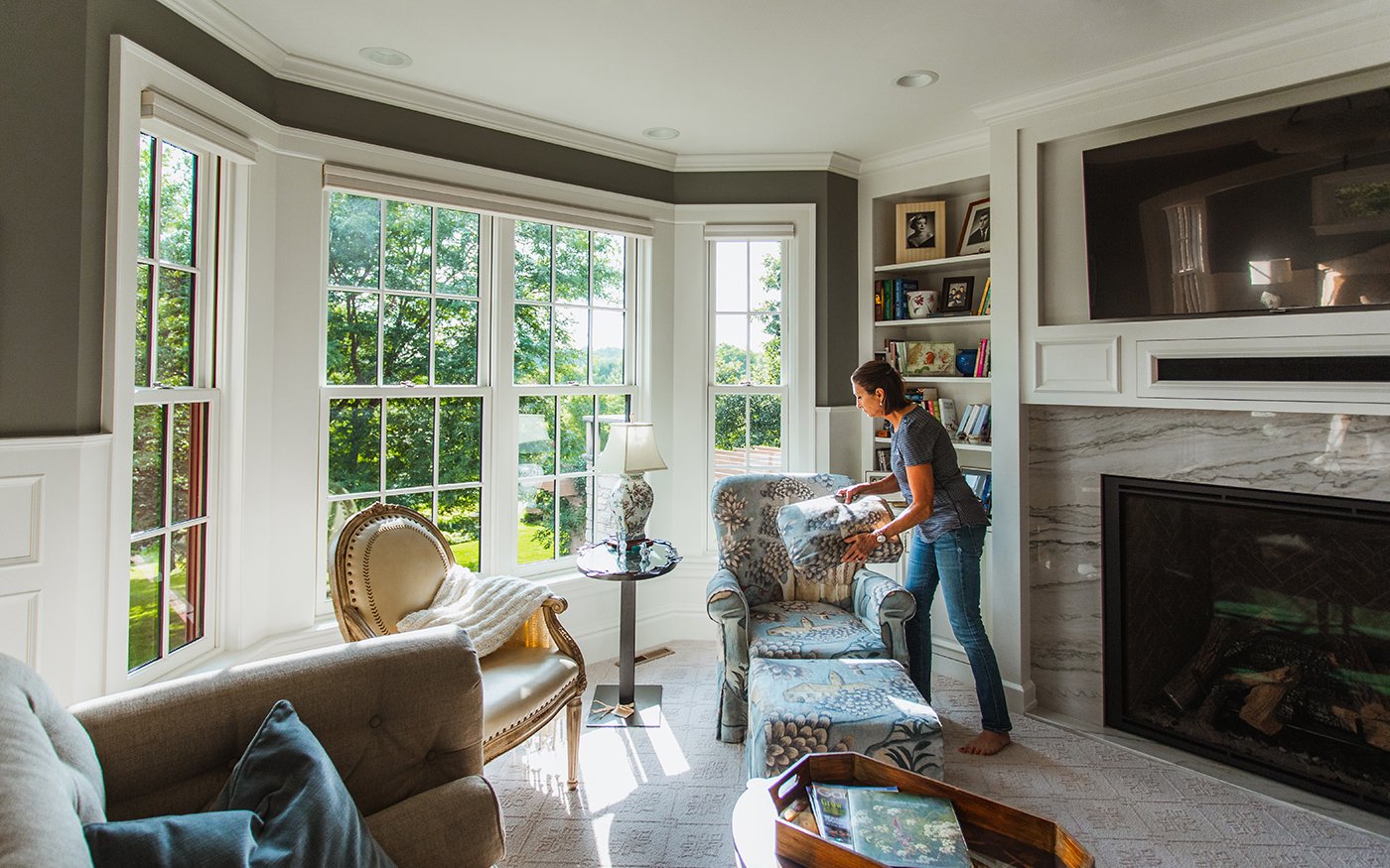 A bay window created from Andersen® A-Series Double-Hung Windows with a white painted interior and full divided light grilles in a colonial pattern.