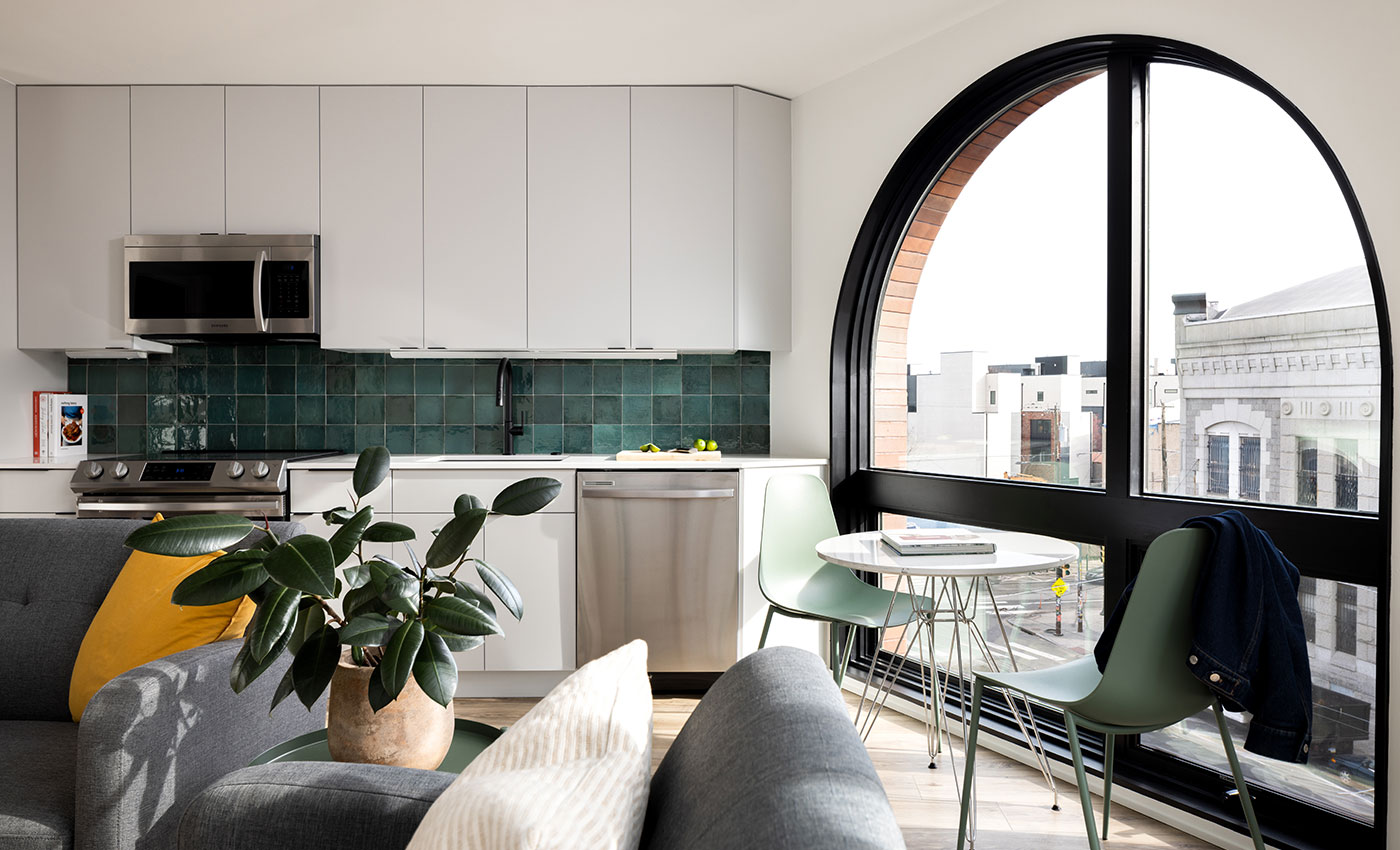 An apartment with a large arched window combination unit made of Andersen® E-Series Specialty Windows.