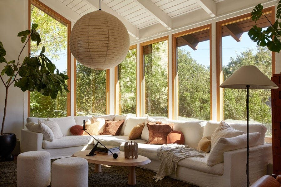 An interior shot of a living room with white oak window frames.