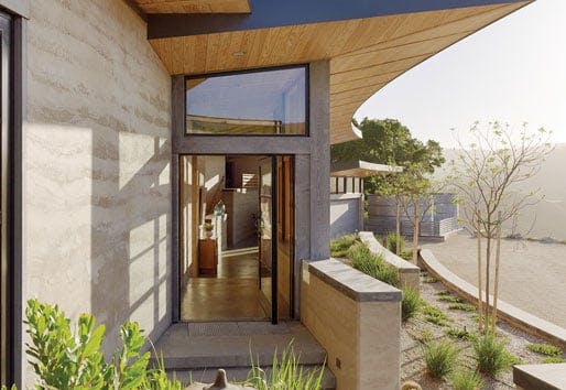 Two views of the home’s entrance, which features a Pivot Door with a clerestory window above.