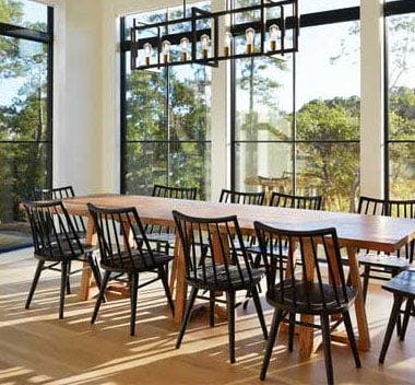 Modern dining room with black Andersen picture and transom windows bringing in natural light.